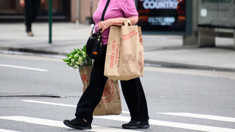 woman carrying trader joe's bags