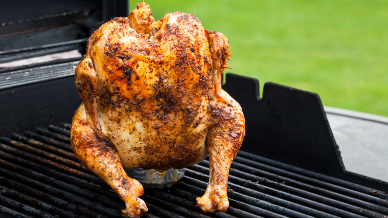 whole grilled chicken on outside grill