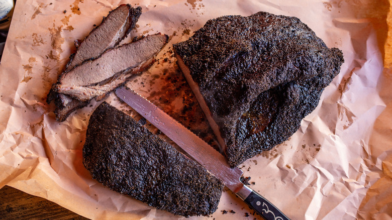 Smoked brisket wrapped in pink butcher paper