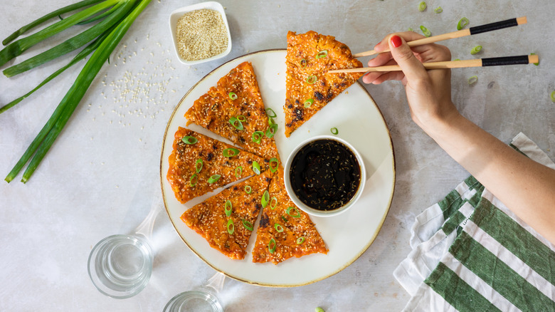 Kimchi pancake wedges on white plate