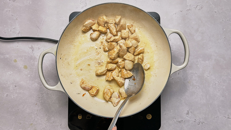 cooked, cubed chicken in skillet