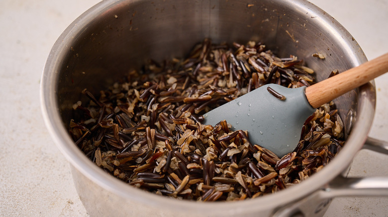 fluffing wild rice in pot