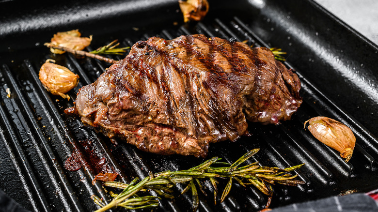 steak being cooked on a grill pan