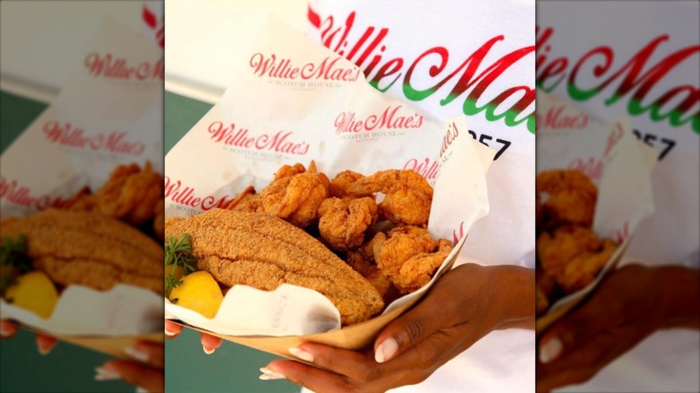 person holds basket of fried food at Willie Mae's
