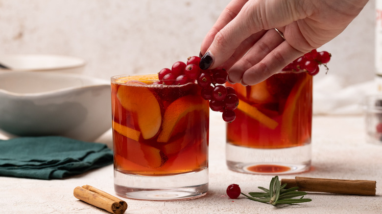 garnishing cocktail with red currants