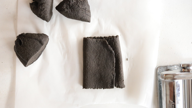 black pasta dough folded into thirds