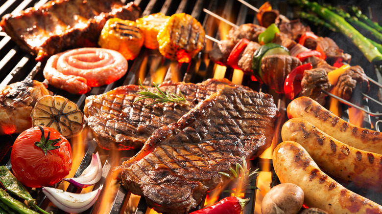 grilling meat and veggies over charcoal