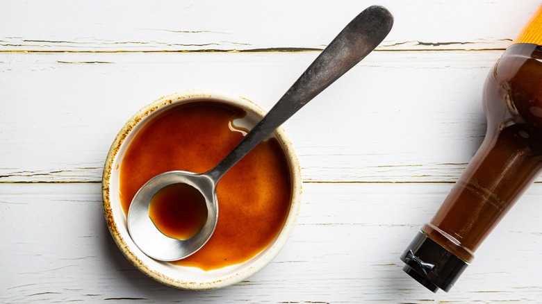 Top-down view of a bowl of Worcestershire sauce with a spoon