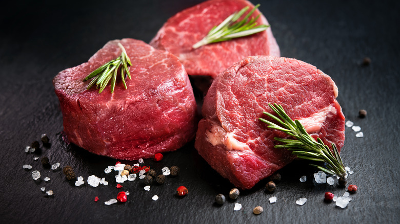 Raw filet mignon on cutting board