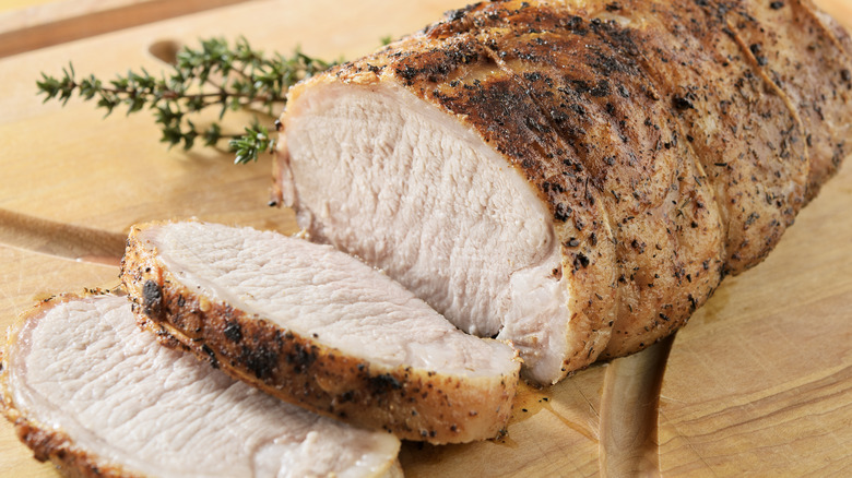 Seasoned pork tenderloin on board