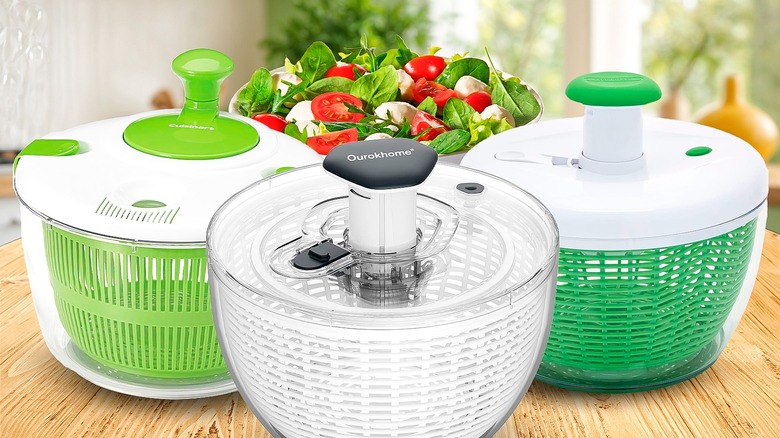 Three salad spinners on a wooden table