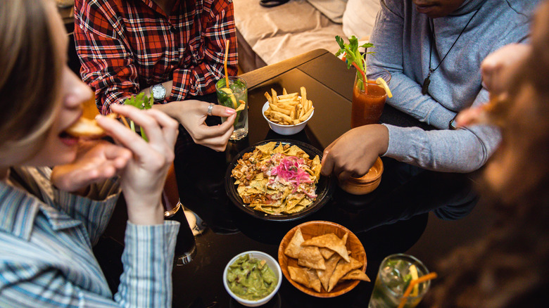 People eating nachos