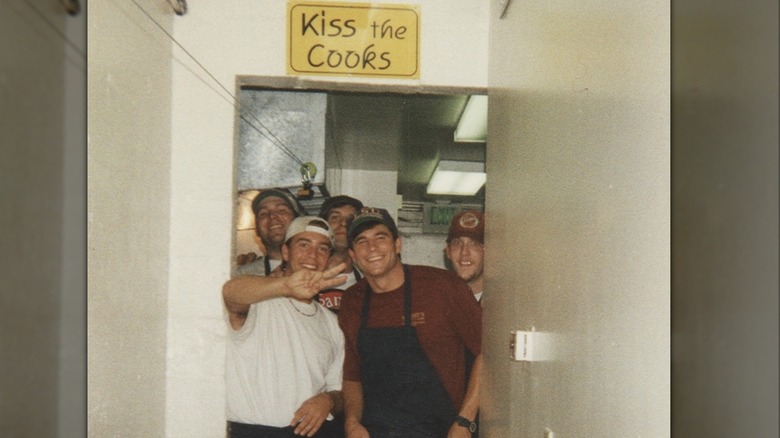 Ted Graves poses with basket of Raising Cane's food.