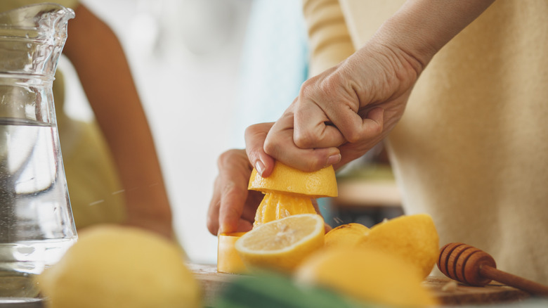 Person juicing a lemon