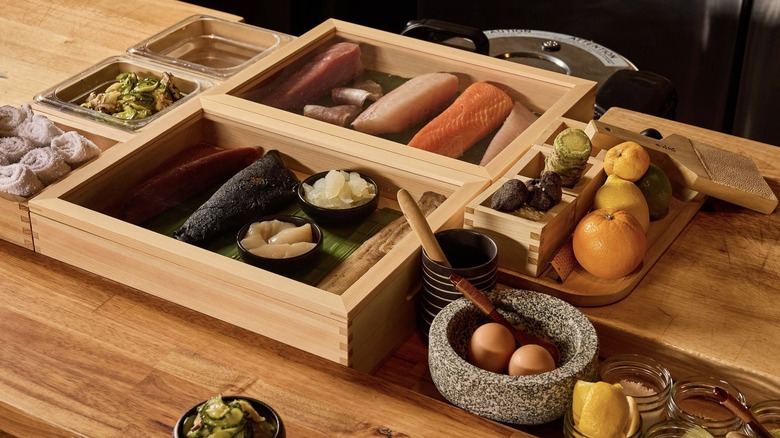 Raw fish and other ingredients on the chef's counter at Sushi by Scratch