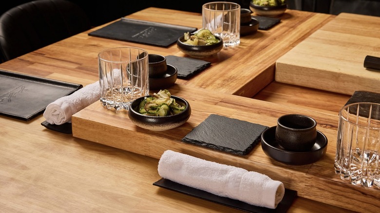 Oshibori on trays at a Sushi by Scratch chef's counter