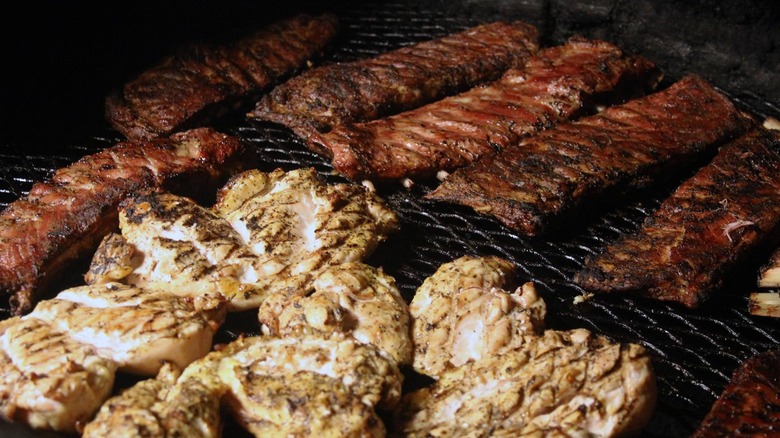 Seasoned BBQ meats on pit