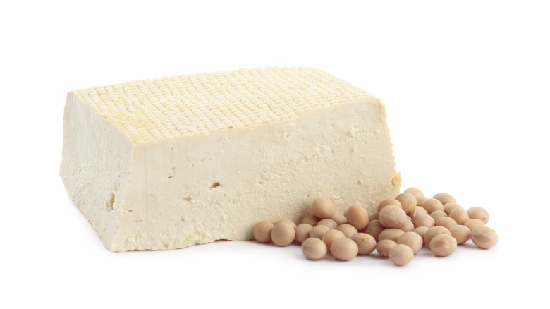 Tofu with soybeans on white background