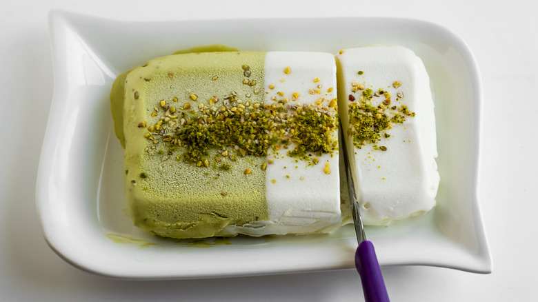 Knife slicing pistachio ice cream