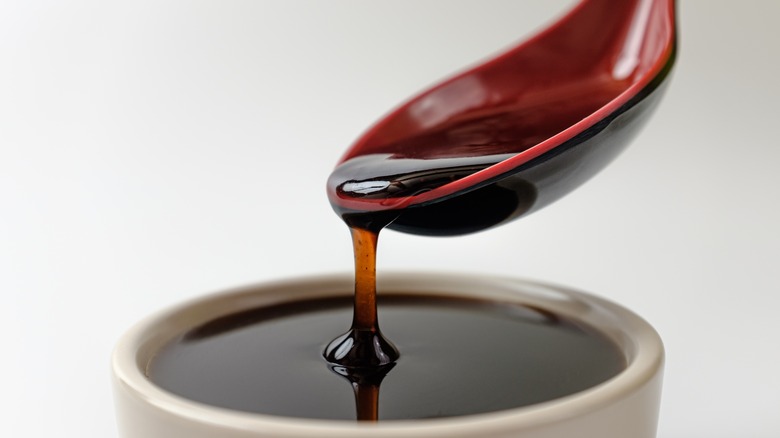 Pouring soy sauce into bowl