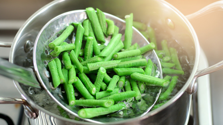 Simmering green beans in pot 