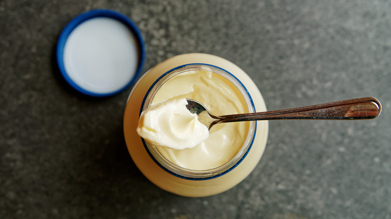 Spoon of mayonnaise on jar