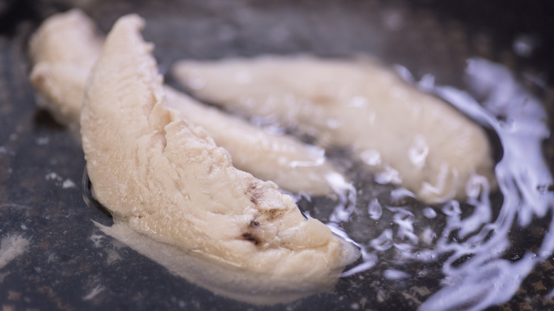 Chicken poaching in water