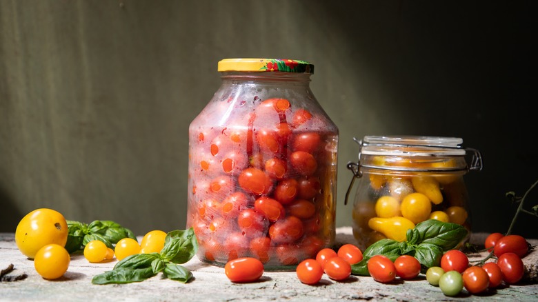 Yellow and red tomatoes in jars