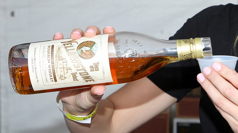 Woman pouring shot of Yellowstone Select