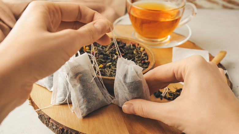 woman's hands with tea bags