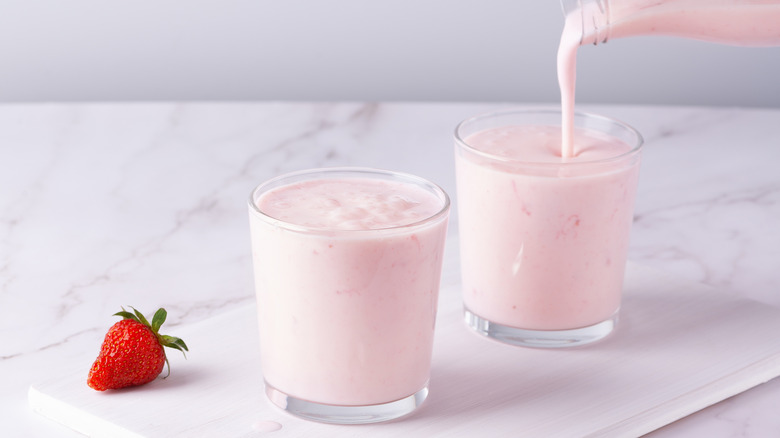 Pouring glass of strawberry buttermilk