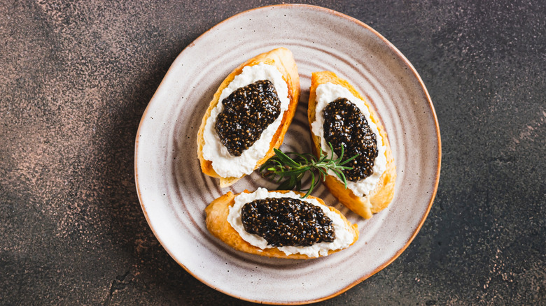 black chia caviar on bread with cream cheese