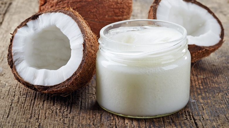 Coconuts and coconut oil on a table