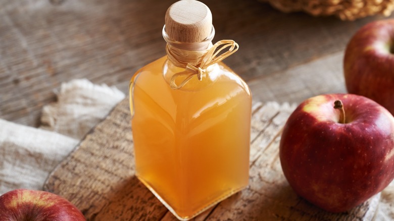 A small glass bottle of apple cider