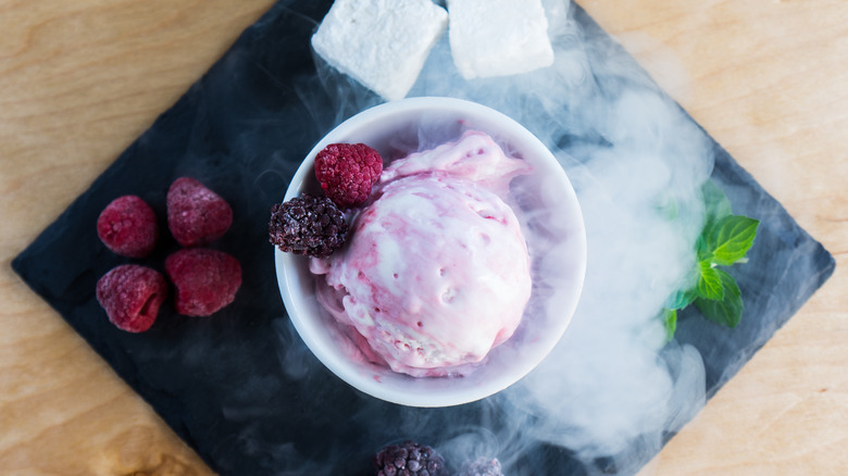 dish of ice cream with berries and smoke