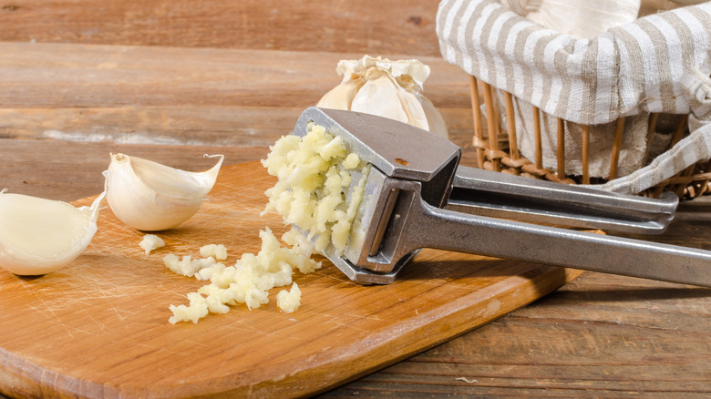 Garlic press on cutting board