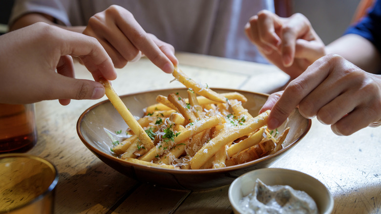 People sharing french fries