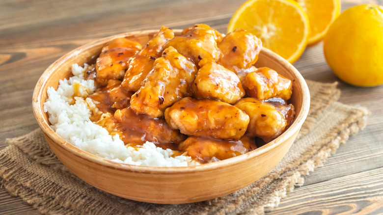 Orange chicken over rice with oranges 