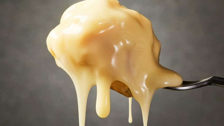 Close-up of bread dipped in dripping fondue