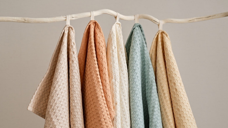 Colored towels hanging from rack 