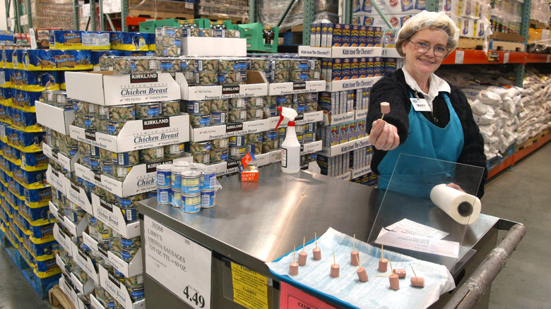 A woman offers a sample at a Costco store