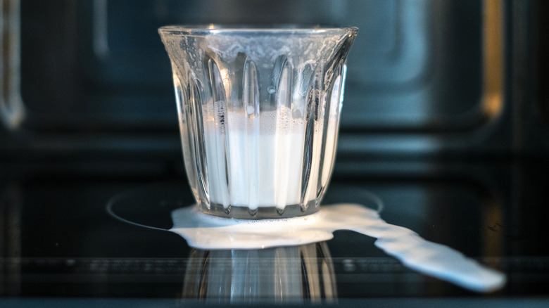 Glass of milk that has boiled over in microwave