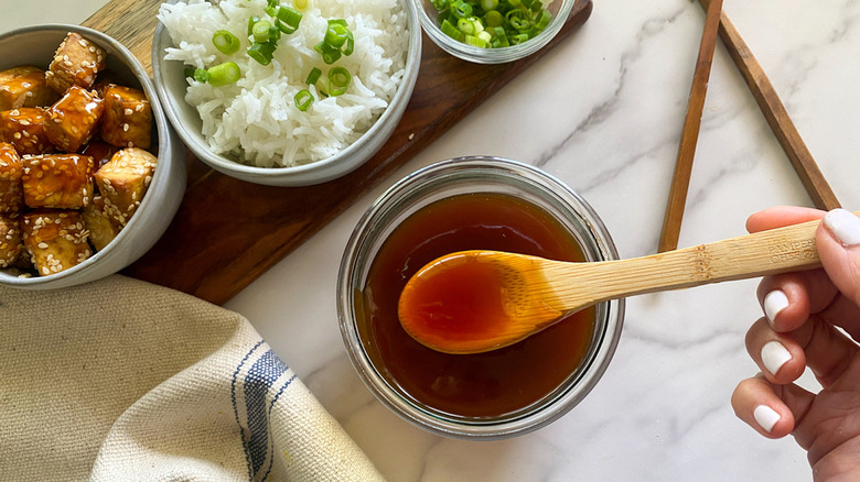 Spoon with sweet and sour sauce