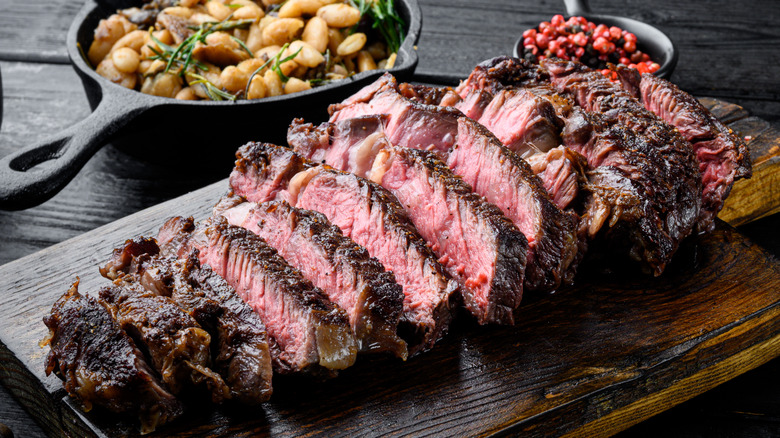 sliced steak on cutting board