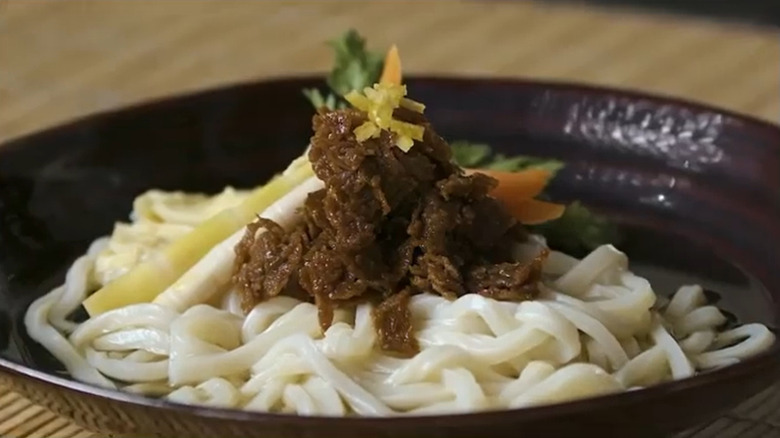 vegan wagyu strips over noodles