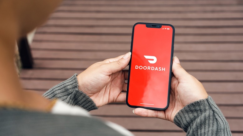 person looking at a doordash app