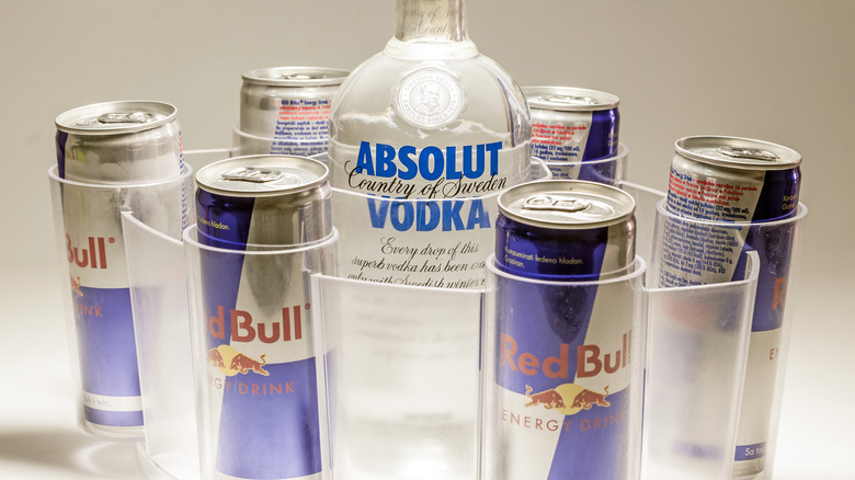 cans of redbull and bottle of Absolut vodka