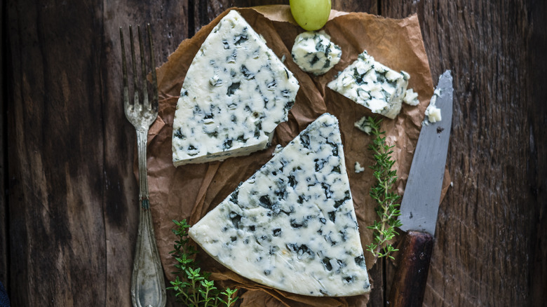 Blue cheese, a fork, and a knife