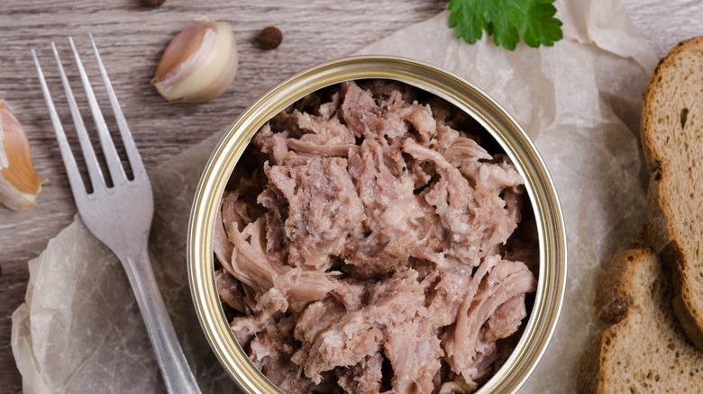 canned chicken beside fork