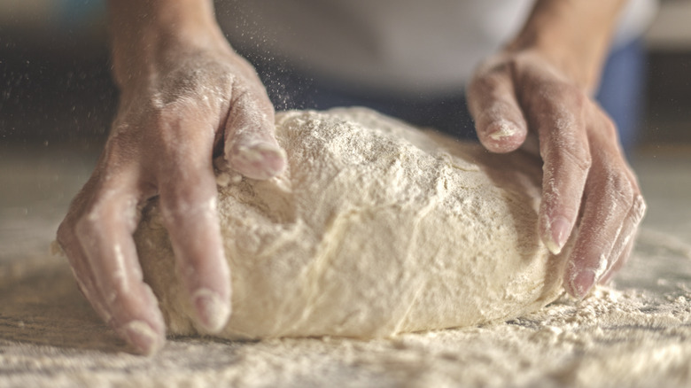 Mixing dough on counter hands